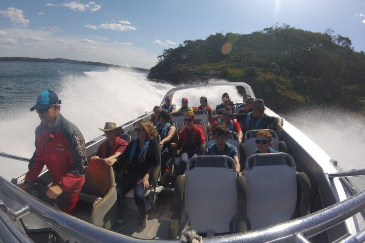 a group of people on a boat in the water