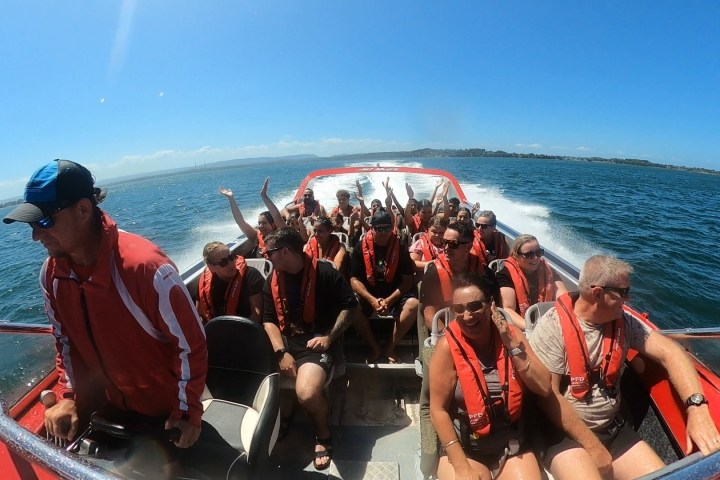a group of people in a boat on a body of water