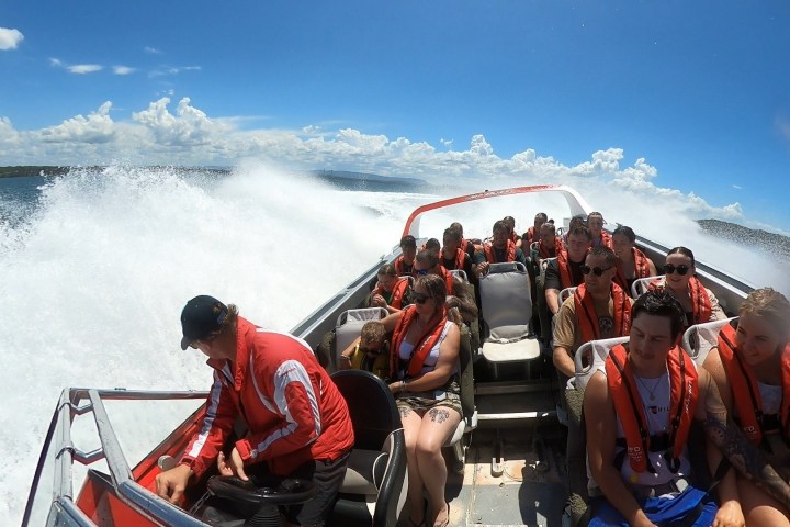 a group of people riding on the back of a boat