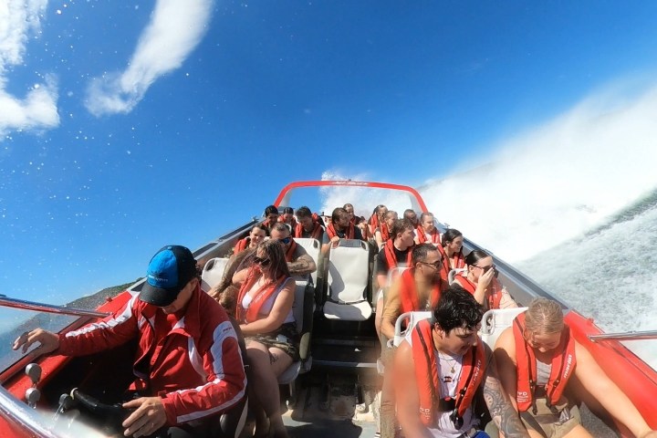 a group of people riding on the back of a boat