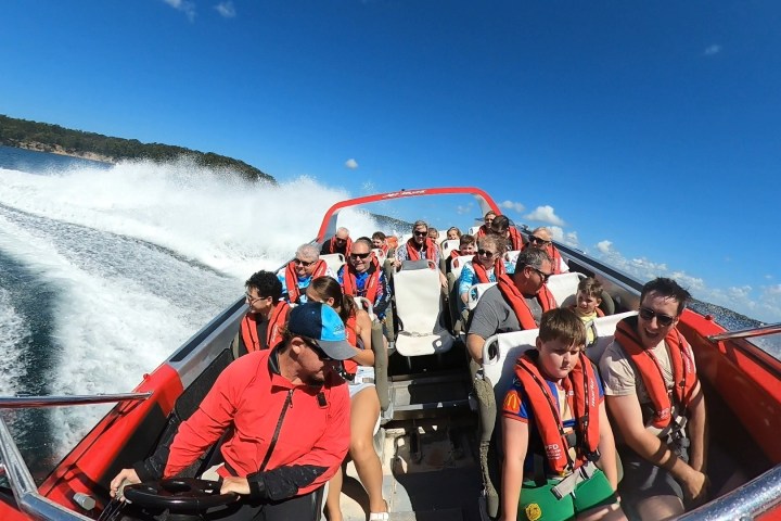 a group of people on a boat in the water