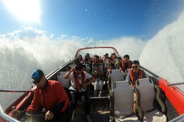 a group of people riding on the back of a boat