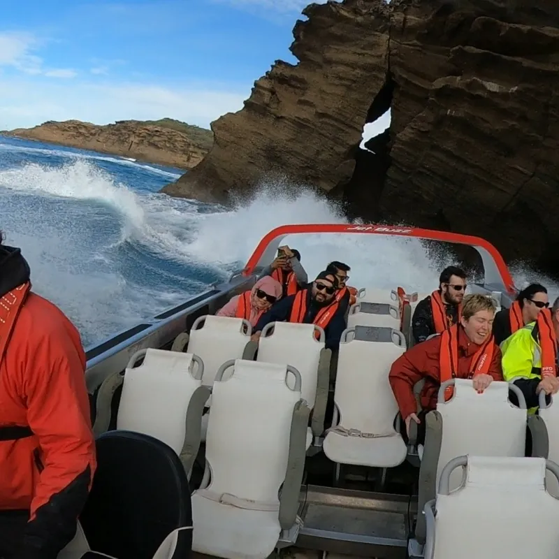 a group of people standing in front of a mountain