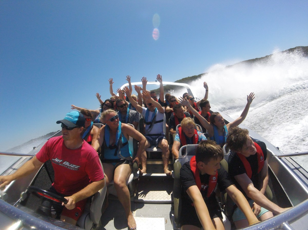 a group of people riding on the back of a boat